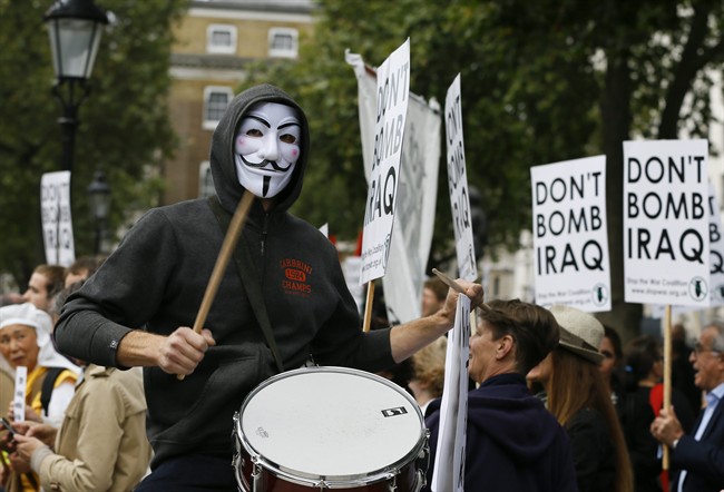 A demonstrator bangs a drum at an anti-war demonstration near Downing Street in London, Thursday, Sept. 25, 2014. The British prime minister said late Wednesday he will ask Parliament to approve joining international airstrikes against the Islamic State group in Iraq. David Cameron announced the move in his address to the U.N. General Assembly. (AP Photo/Kirsty Wigglesworth).