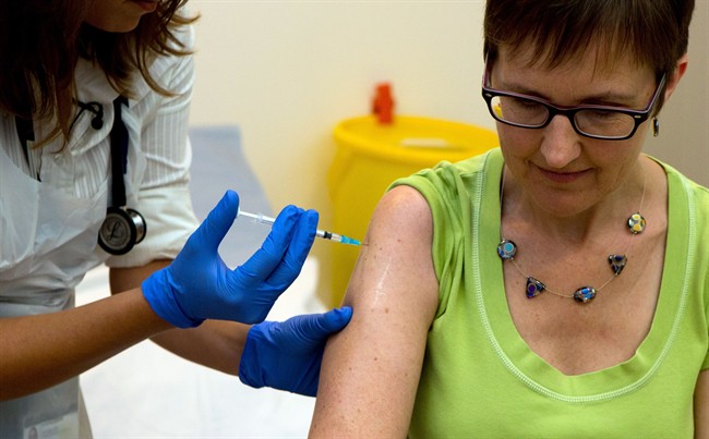 Dr Felicity Hartnell, who is a clinical research fellow at Oxford University, injects former nurse Ruth Atkins the first of 60 healthy volunteers in the UK who will receive an experimental vaccine against Ebola.