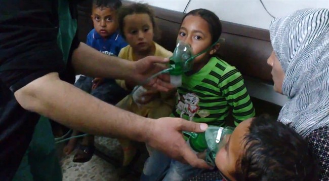In this image taken from video posted on April 16, 2014, children are seen receiving oxygen in Kfar Zeita, a rebel-held village in Hama province Syria, after an alleged toxic gas attack on civilians.