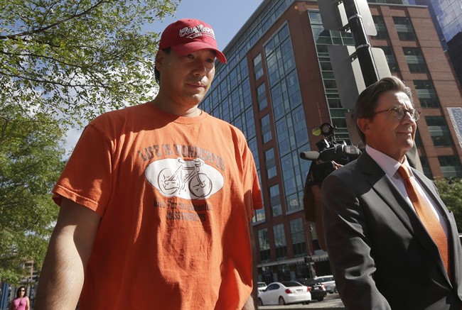 Glenn Adam Chin, left, a former supervisory pharmacist at the New England Compounding Center, walks with his attorney Paul Shaw, right, after appearing in federal court, Thursday, Sept. 4, 2014, in Boston.