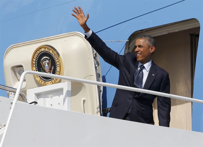 President Barack Obama waves as he boards Air Force One at Andrews Air Force Base, Md., Tuesday, Sept. 2, 2014.