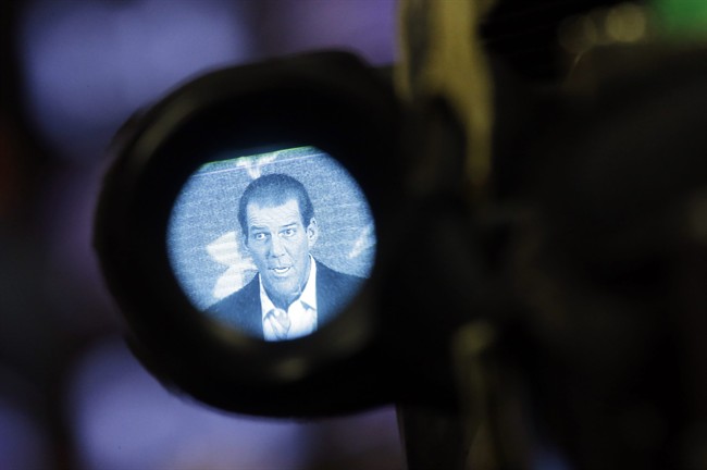 Baltimore Ravens owner Steve Bisciotti is seen through a television camera's viewfinder as he addresses the controversy surrounding former running back Ray Rice at an NFL football news conference, Monday, Sept. 22, 2014, in Owings Mills, Md.