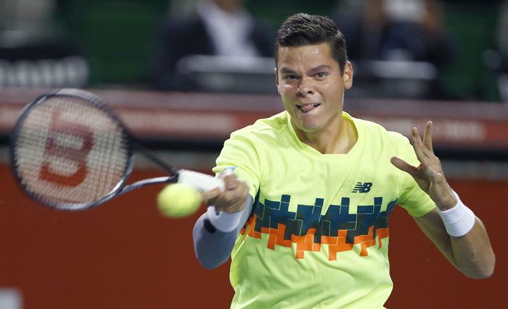 Milos Raonic a shot against Bernard Tomic during their first round match of Japan Open Tennis Championships in Tokyo, Tuesday, Sept. 30, 2014. 