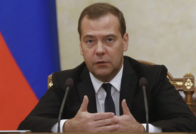 Russian Prime Minister Dmitry Medvedev heads the Cabinet meeting in the government headquarters in Moscow, Russia, Thursday, Sept. 18, 2014.