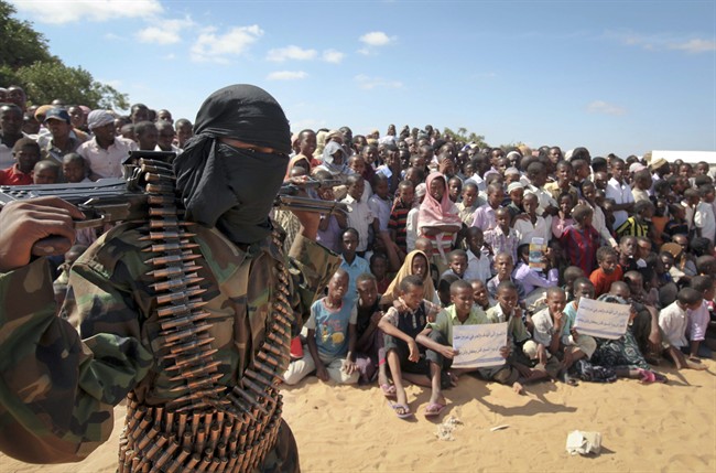 In this Feb. 13, 2012 file photo, an armed member of the militant group al-Shabab attends a rally in support of the merger of the Somali militant group al-Shabab with al-Qaida, on the outskirts of Mogadishu, Somalia. 