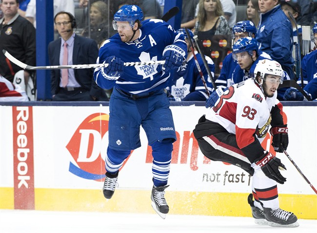 Toronto Maple Leafs forward Phil Kessel, left, avoids a hit from Ottawa Senators forward Mika Zibanejad during third period pre-season NHL hockey action in Toronto on Wednesday, September 24, 2014.