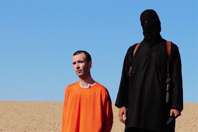 GRAPHIC CONTENT: This image made from video posted on the Internet by Islamic State militants and provided by the SITE Intelligence Group, a U.S. terrorism watchdog, on Saturday, Sept. 13, 2014, purports to show British aid worker David Haines before he was beheaded. The video emerged hours after the family of Haines issued a public plea on Saturday urging his captors to contact them. The 44-year-old Haines was abducted in Syria in 2013 while working for an international aid agency.