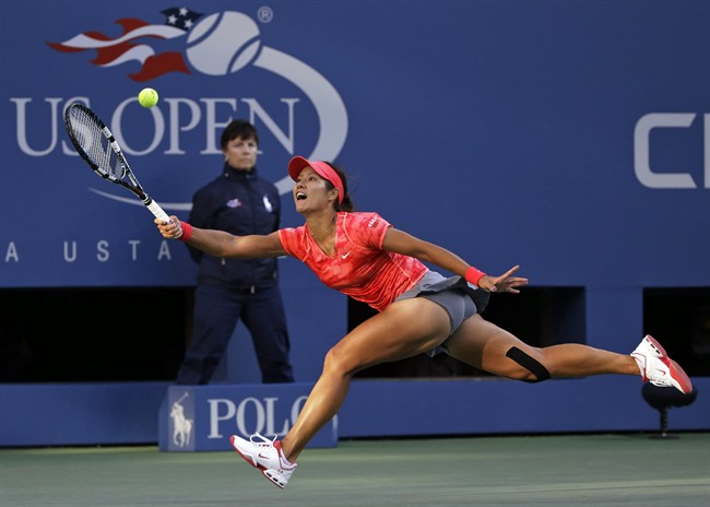 In this Sept. 6, 2013, file photo, Li Na, of China, returns a shot to Serena Williams during the semifinals of the U.S. Open tennis tournament in New York.