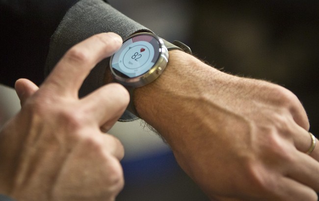 Steve Sinclair, Motorola's vice president of product management, demonstrates the new Moto 360 circular smartwatch, the company's first, during an interview.