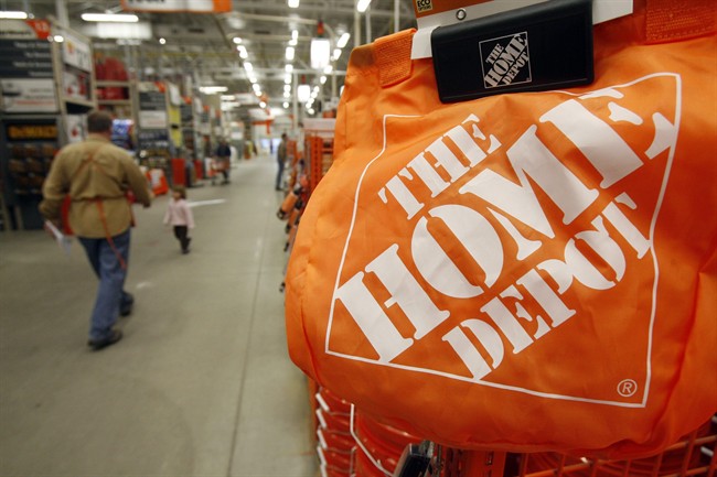 In this Feb. 22, 2010 file photo, shoppers walk through the aisles at the Home Depot store in Williston, Vt. 