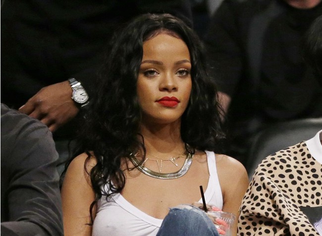 This April 25, 2014 file photo shows singer Rihanna watching Game 3 of an NBA basketball first-round playoff series between the Brooklyn Nets and the Toronto Raptors in New York. 