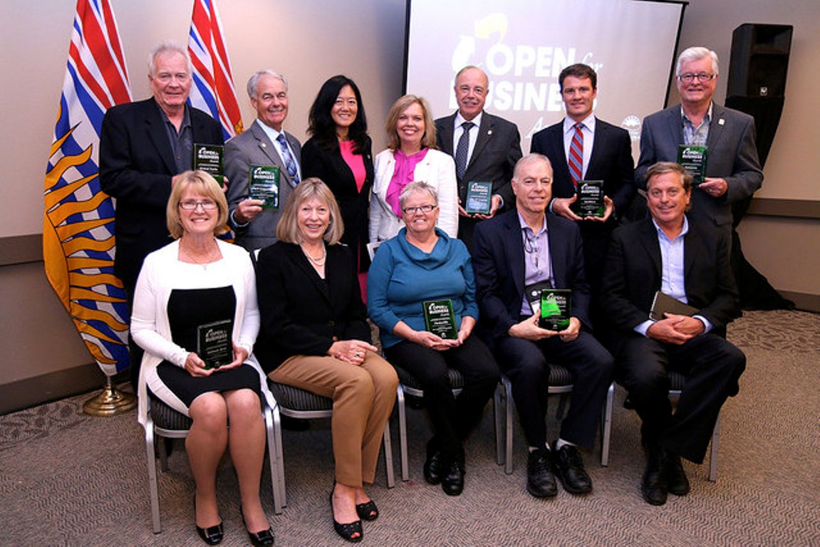 Municipality leaders 9 communities accept the 2014 Open for Business award.