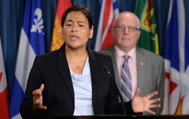 Former Native Women’s Association of Canada President Michele Audette speaks as Alex Neve, Secretary-General of Amnesty International Canada, looks on during a press conference on Parliament Hill in Ottawa on Monday, September 29, 2014