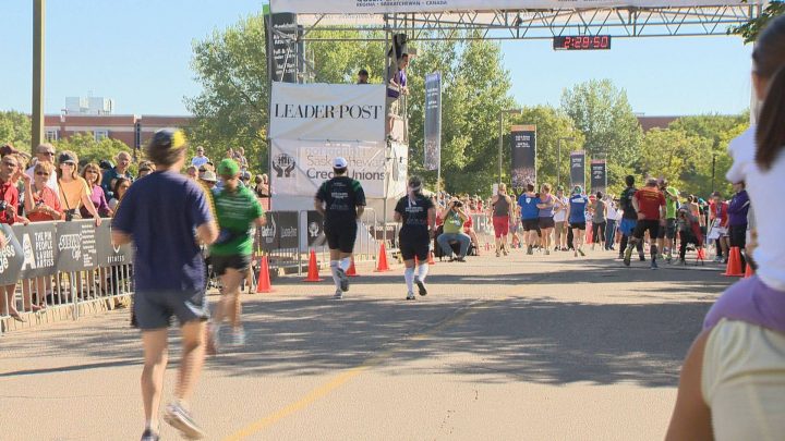 Runners are seen on their way to the Queen City Marathon finish line on Sunday. Over 5,500 people participated in the event over the weekend.