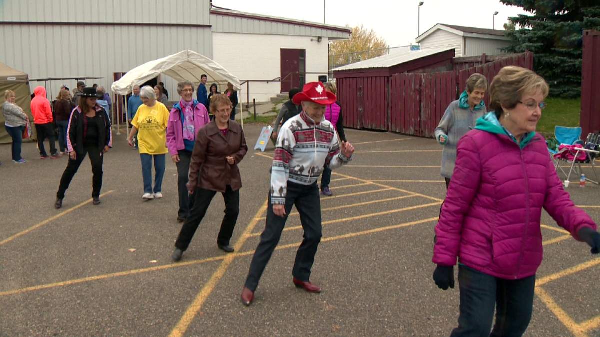 Members of the Queensland community line dancing at the community's 40th birthday party Saturday.  