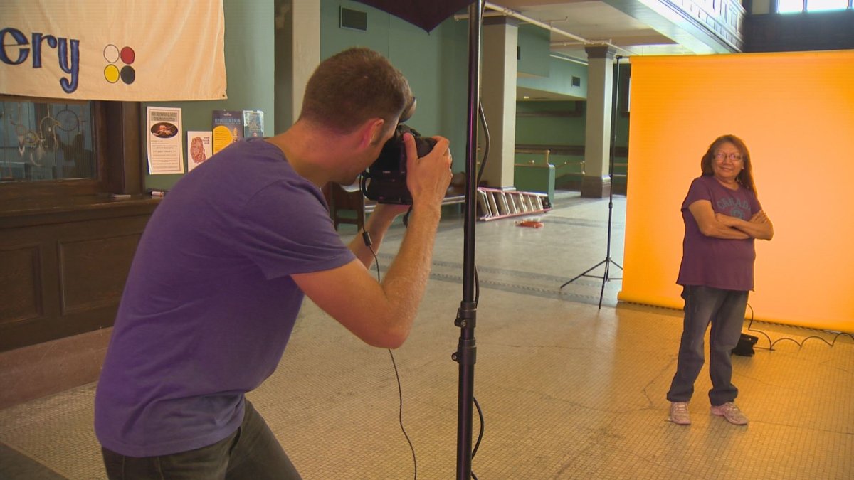 A guest poses for her resume photo during the first-ever 'raising the bar' for the homeless services fair.
