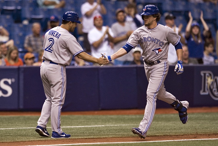 Toronto Blue Jays third base coach Luis Rivera (2) congratulates Colby Rasmus, who pinch-hit a home run off Tampa Bay Rays reliever Steve Geltz during the 10th inning of a baseball game Thursday, Sept. 4, 2014 in St. Petersburg, Fla.
