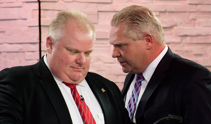 Mayor Rob Ford, left, listens to his brother and campaign manager Doug Ford, right, in a file photo. 