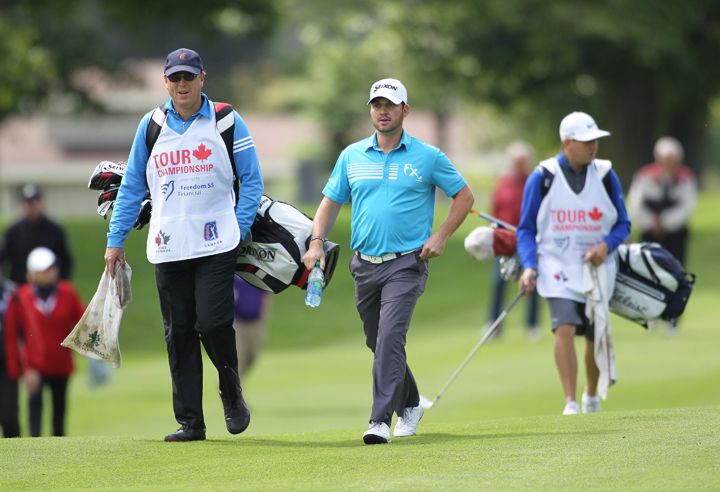 Ryan Williams (middle) and caddy Robert Thompson (L) at the PGA Tour Canada Championship at Sunningdale Golf & Country Club on September 14, 2014 in London, Ontario.
