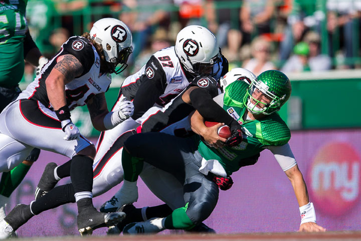 Wallace Miles #84 of the Ottawa Redblacks scores a late first half touchdown breaking the tackle of Tristan Jackson #38 of the Saskatchewan Roughriders in a game between the Ottawa Redblacks and Saskatchewan Roughriders in week 13 of the 2014 CFL season at Mosaic Stadium on September 21, 2014 in Regina, Saskatchewan, Canada.