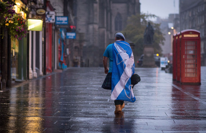 A lone YES campaign supporter walks down a street in Edinburgh after the result of the Scottish independence referendum, Scotland, Friday, Sept. 19, 2014. 