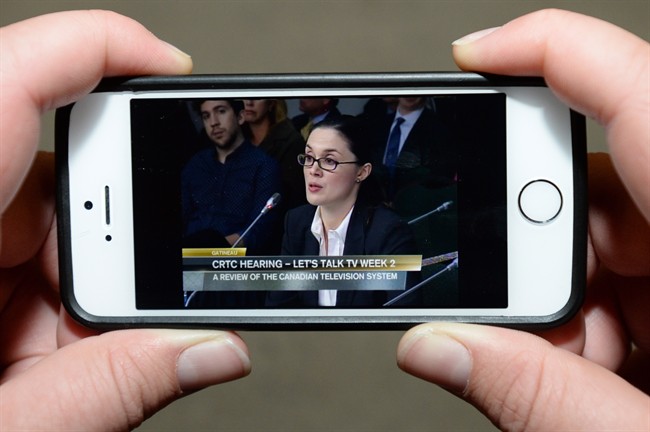 A viewer watches a live stream of Netflix global public policy director Corie Wright speaking before the CRTC. Canadian regulators held hearings into the future of Canadian TV services last month.