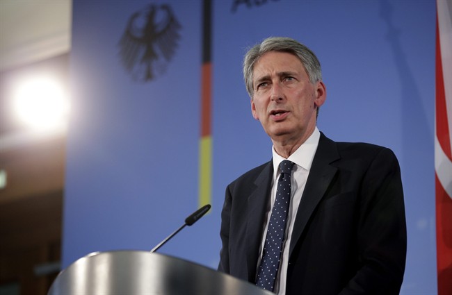 The Foreign Minister of Britain, Philip Hammond addresses the media during a joint press conference with German Foreign Minister Frank-Walter Steinmeier after a meeting in Berlin, Germany, Thursday, Sept. 11, 2014.