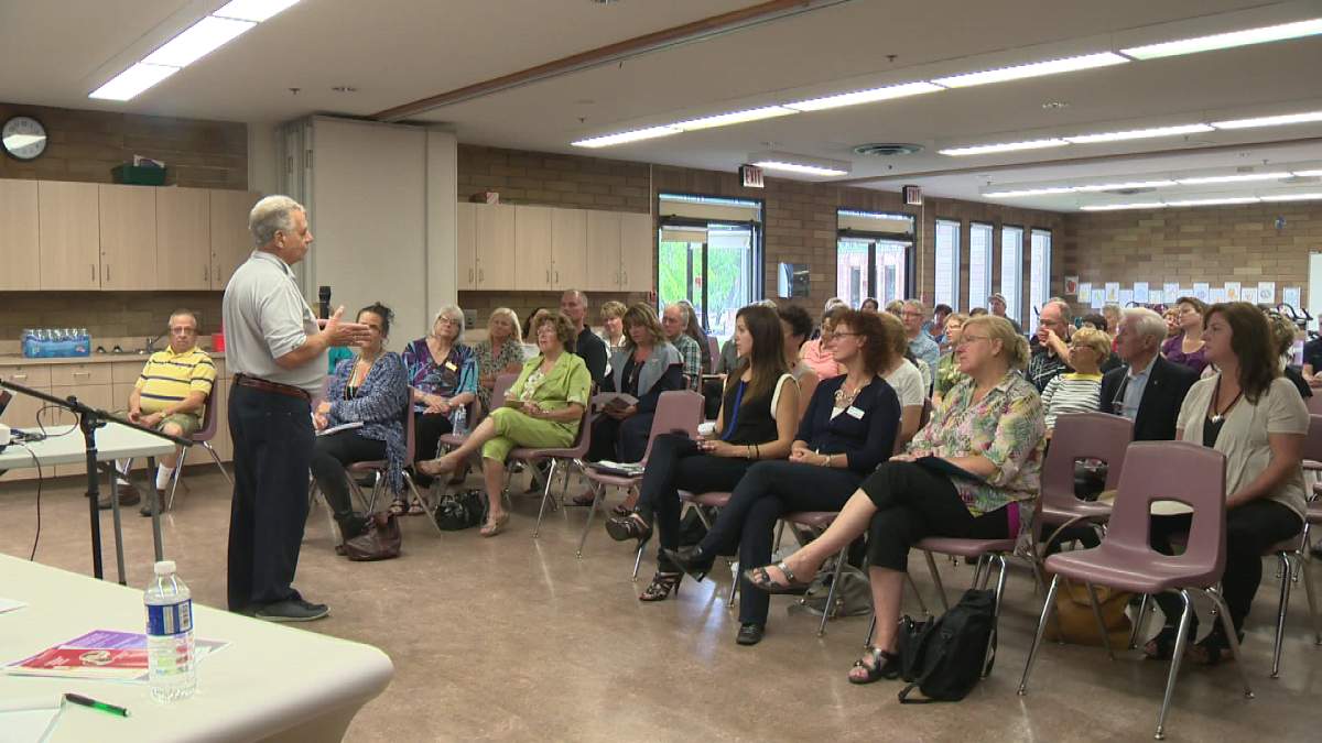 Man who lost son to suicide addresses crowd at town hall Monday. 