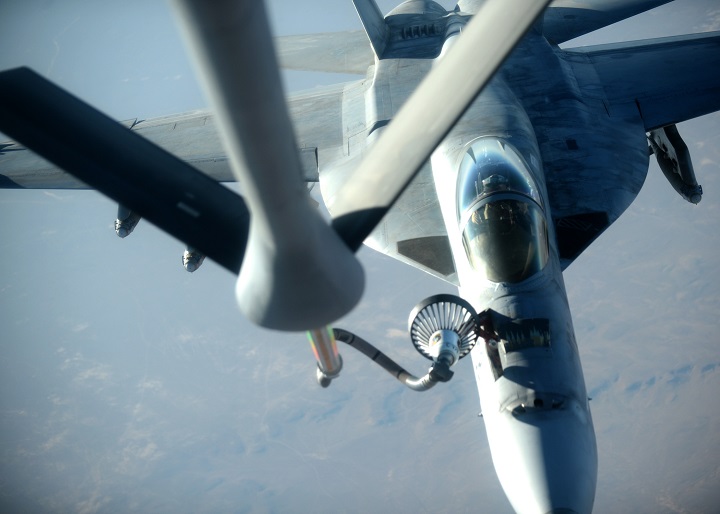 In this Tuesday, Sept. 23, 2014 file photo released by the U.S. Air Force, a U.S. Navy F-18E Super Hornet fighter jet receives fuel from a KC-135 Stratotanker over northern Iraq after conducting airstrikes in Syria. 