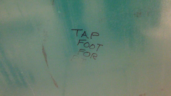 A glimpse of the writing on a bathroom stall in the Sears at Fairview Pointe-Claire mall in Montreal.