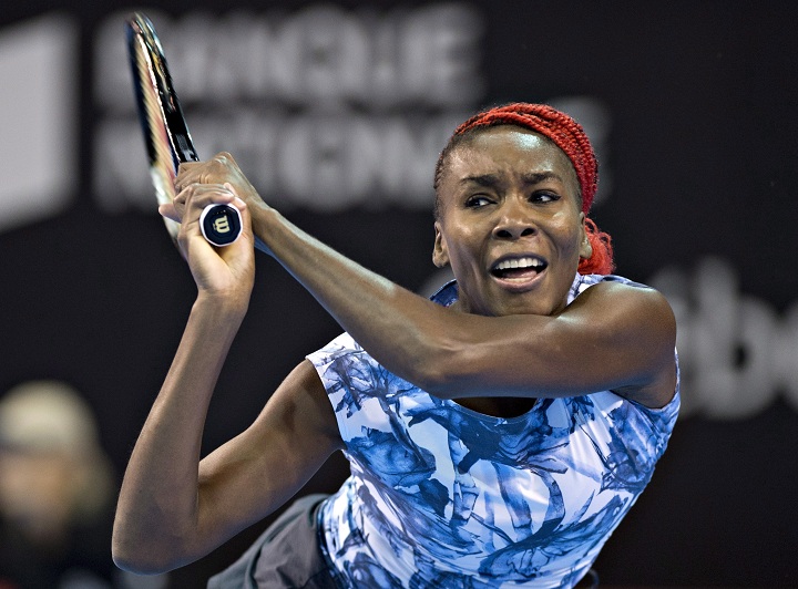 Top seed Venus Williams, of the USA, returns to Francoise Abanda, of Montreal, during the first round at the WTA Banque Nationale Cup in Quebec City on Tuesday, September 9, 2014.