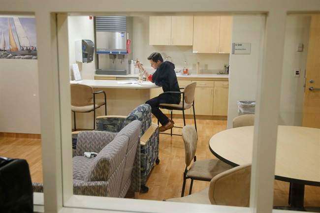 FILE - This Jan. 14, 2014 file photo shows Daniel Bennett quarantined in an isolation unit at the National Institute of Health (NIH) in Bethesda, Md., during research for a better flu vaccine.
