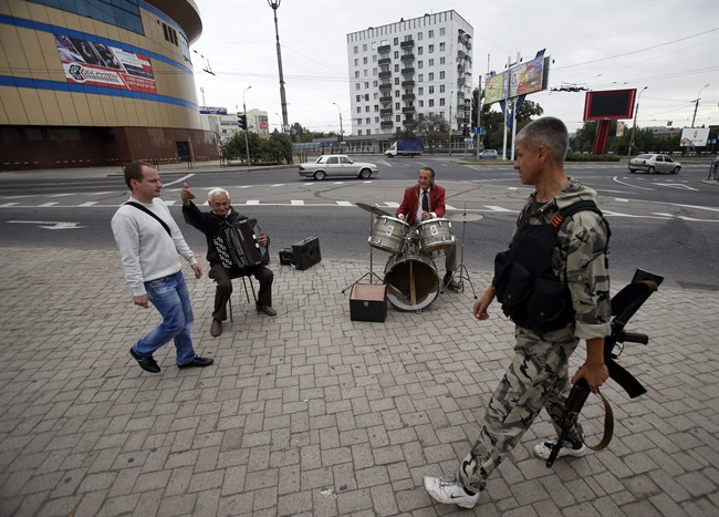 Street musicians perform in the town of Donetsk, eastern Ukraine, Monday, Sept. 22, 2014. A cease-fire was called on Sept. 5 but has been violated repeatedly. 