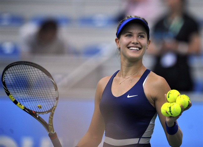 Eugenie Bouchard smiles after winning the women's quarterfinal match against Alize Cornet of France at the WTA Wuhan Open tennis tournament in Wuhan, China's Hubei Province, Thursday, Sept. 25, 2014.