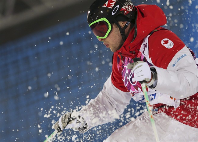 Canada's Alex Bilodeau makes his last run in the men's moguls final at the 2014 Winter Olympics, Monday, Feb. 10, 2014, in Krasnaya Polyana, Russia. Bilodeau won the gold medal. Bilodeau is retiring to take up accountancy.