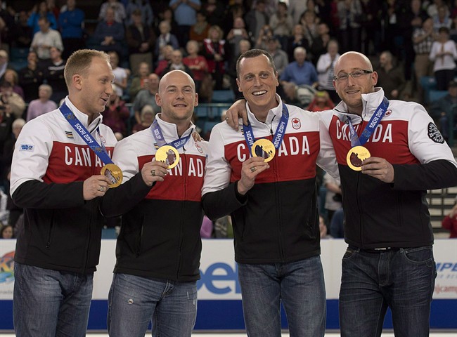 Olympic curling gold medallists Brad Jacobs, Ryan Fry, Ryan Harnden and E. J. Harnden, left to right, display their medals as they make an appearance at the Tim Hortons Brier in Kamloops, B.C. on Saturday, March 8, 2014. Never mind the new quadrennial. Team Brad Jacobs wants to be a force on the men's curling scene for at least the next eight years. THE CANADIAN PRESS/Andrew Vaughan.