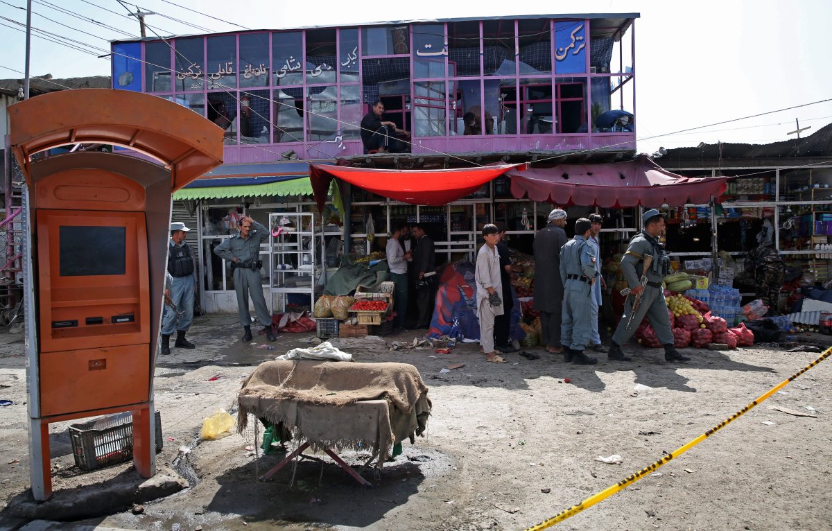 Afghan police and civilians inspect the site of a suicide attack near the International Airport of Kabul, Afghanistan, Monday, Sept. 29, two days before today's attack.  (AP Photo/Massoud Hossaini).