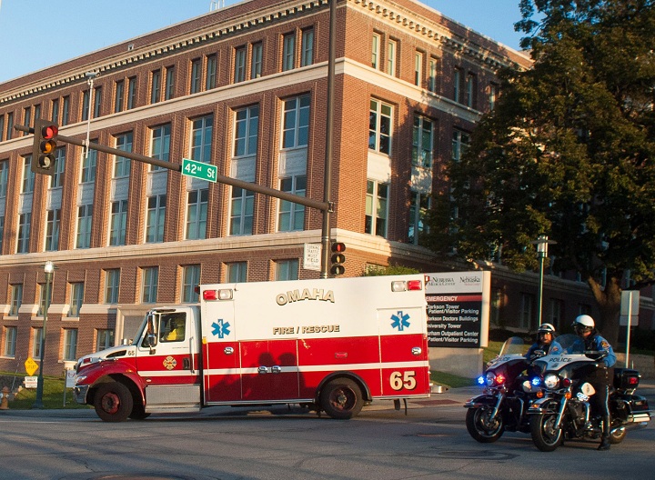 An ambulance transports Ashoka Mukpo, who contracted Ebola while working in Liberia, to the Nebraska Medical Center's specialized isolation unit Monday, Oct. 6, 2014, in Omaha, Neb., where he will be treated for the deadly disease. 