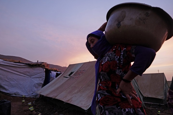 Displaced people from the minority Yazidi sect carry out daily activities at a refugee camp in Zakho near the Syrian border in northern Iraq on October 10, 2014.