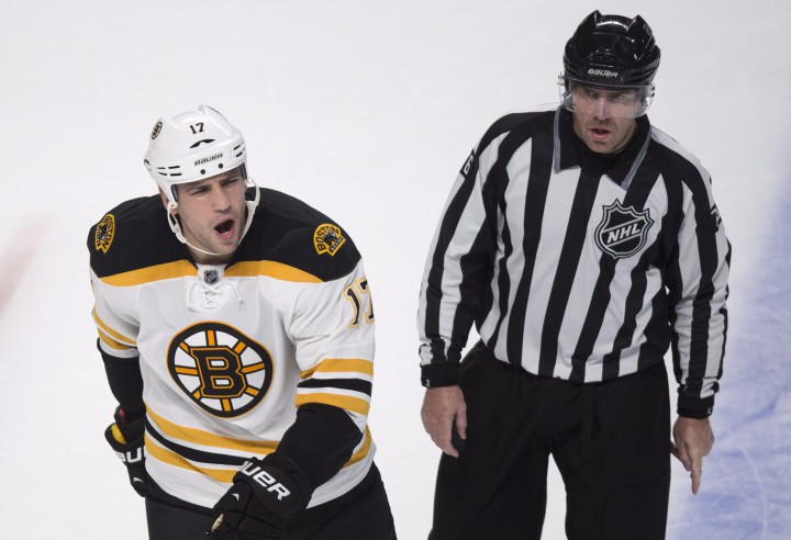 Boston Bruins' Milan Lucic reacts as he is escorted off the ice by linesman Michel Cormier after receiving a minor penalty in the final seconds of their game against the Montreal Canadiens during NHL hockey action Thursday, October 16, 2014 in Montreal. The Canadiens beat the Bruins 6-4.