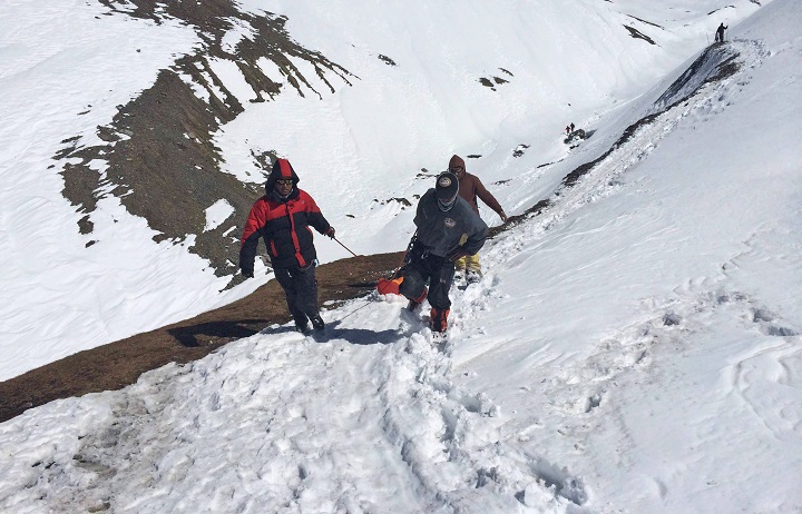 In this handout photo provided by the Nepalese army, rescue team members carry the body of an avalanche victim at Thorong La pass area in Nepal, Friday, Oct. 17, 2014. 