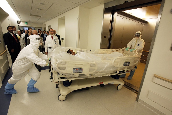 In this photo provided by the UCLA Health System, doctors and staff participate in a preparedness exercise on diagnosing and treating patients with Ebola virus symptoms, at the Ronald Reagan UCLA Medical Center in Los Angeles.