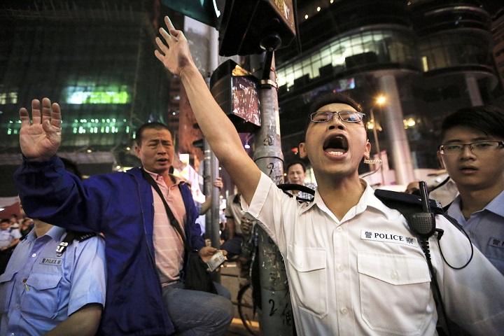 An anti-occupy protester shouts against pro-democracy protesters in Hong Kong on Oct. 23, 2014. 