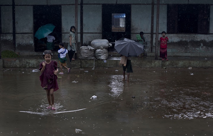 In this June 26 2014 photo, Rohingya children walk to school at The Chaung village school, north of Sittwe, Rakhine State, Myanmar.