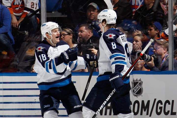 Jacob Trouba (right) of the Winnipeg Jets celebrates his powerplay goal at against the New York Islanders with Bryan Little on Tuesday in Uniondale, New York.
