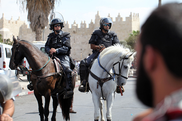 Israeli police check the age of Palestinians entering the holy site for Friday prayer on September 26, 2014 in Jerusalem. Palestinians not allowed to enter to the Al-Aqsa Mosque for Friday prayer, perform their prayers outside the mosque as Israeli police set up barricade for under 50 year-old Muslim worshippers.
