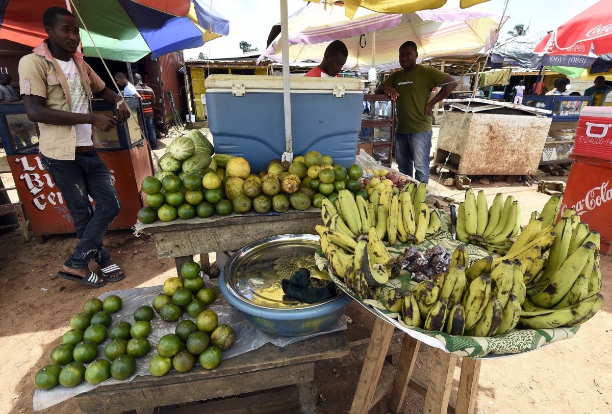 A man sells fruits and vegetables in a market on October 1, 2014 in Monrovia. Liberia has been hit the hardest by the worst-ever outbreak of Ebola, which has killed more than 3,000 people in west Africa. AFP PHOTO / PASCAL GUYOT        (Photo credit should read PASCAL GUYOT/AFP/Getty Images).