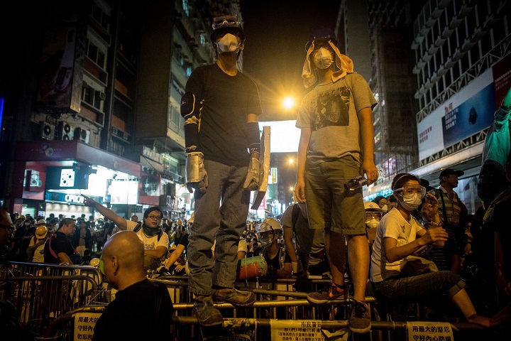 Pro-democracy protesters guard a barricade in anticipation of clashes with police on a street in Mong Kok on October 20, 2014 in Hong Kong, Hong Kong. Police have begun to take measures to remove the blockades put in place by pro democracy supporters following weeks of protests. Hong Kong's Chief Executive Leung Chun-ying has set talks for October 21 between protest groups and government officials.  