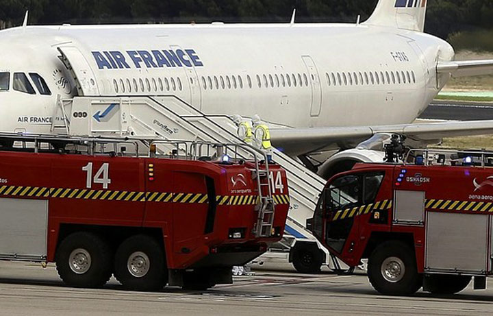 Spanish authorities isolated an Air France plane at Madrid's airport and activated emergency health procedures after one of the passengers was reported to have a fever and shivers in what is being treated as a suspected Ebola case, officials said Thursday.