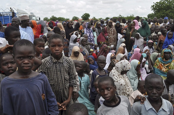 Civilians who fled their homes following an attack by Islamist militants in Bama, take refuge at a school in Maiduguri, Nigeria, Tuesday, Sept. 9, 2014. 